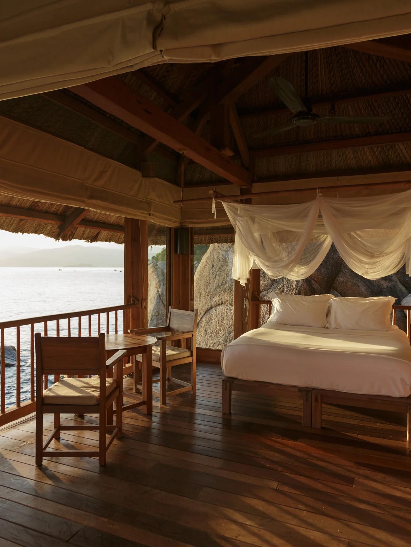 The Six Senses Ninh Van Bay villa bedroom space with a rustic, refined style close to nature