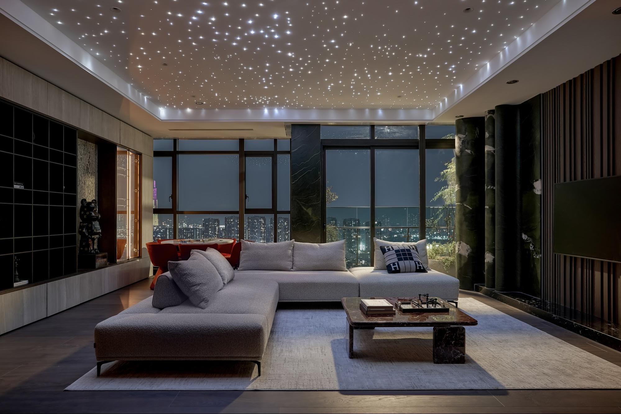 The bustling cityscape is captured in full view through the tempered glass walls.