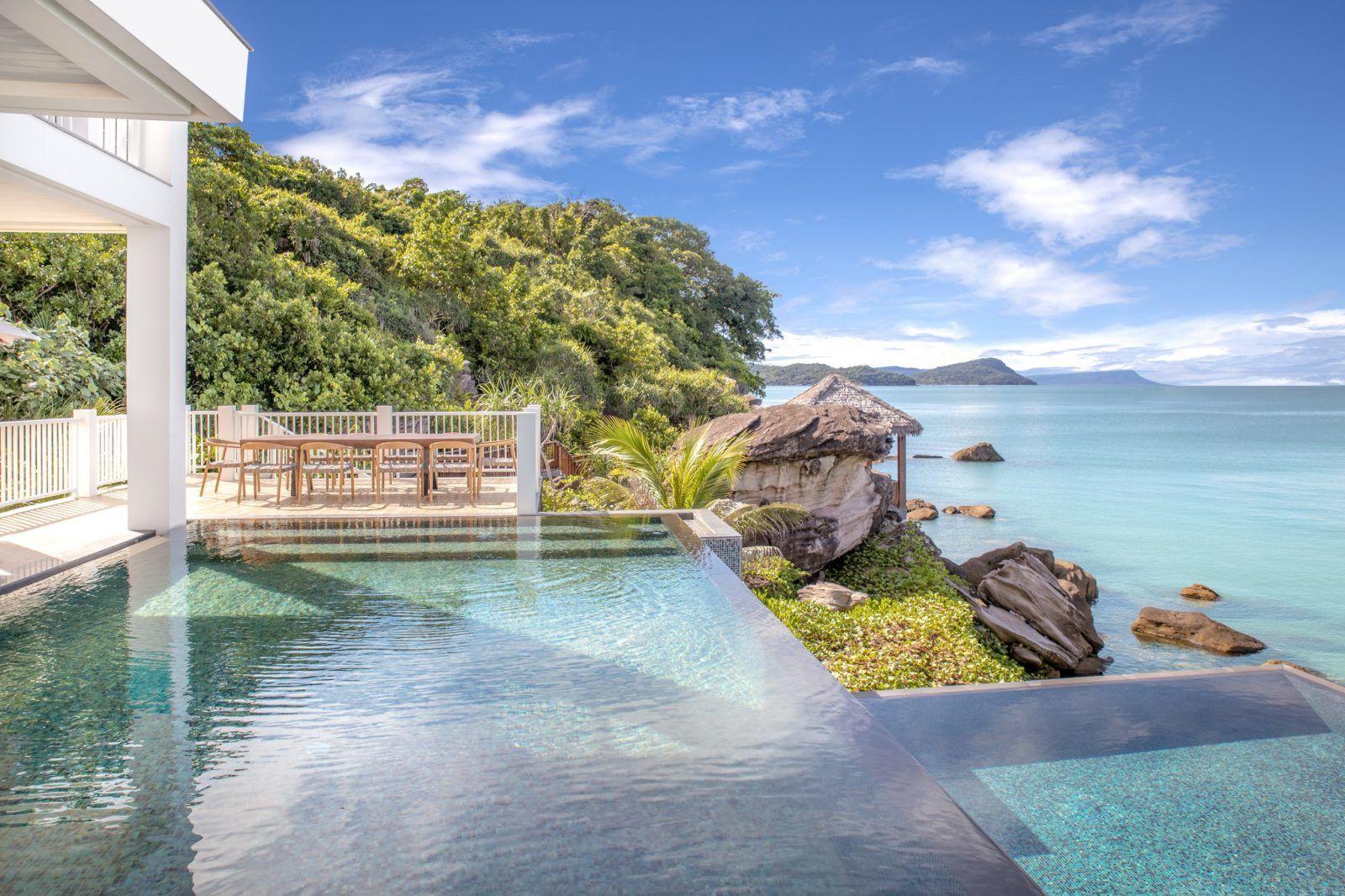 A beachfront villa design with an open space, creating a connection between the interior and the tropical landscape