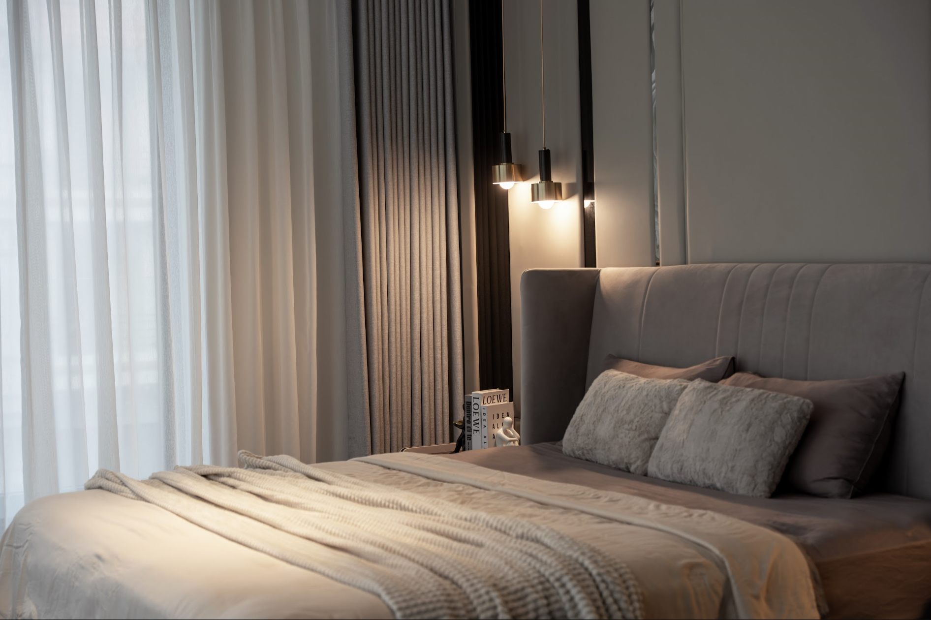The master bedroom in the Phu Gia District 7 villa is refined with a neutral palette, bringing a relaxing and private feel.